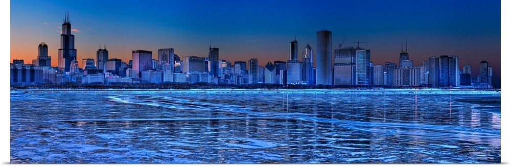 Large, landscape photograph of the icy waters of Lake Michigan in front of the Chicago skyline at dusk.