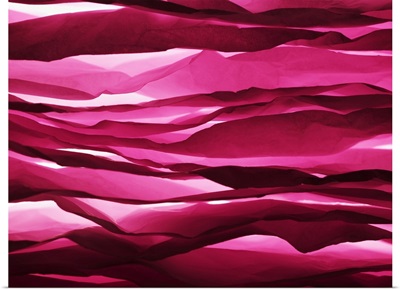 Layered sheets of crumpled pink paper.