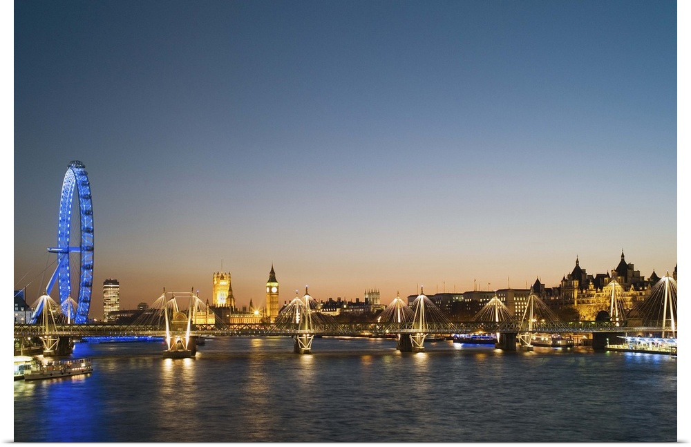 UK, London, view along River Thames towards Houses of Parliament and Millennium Wheel at dusk