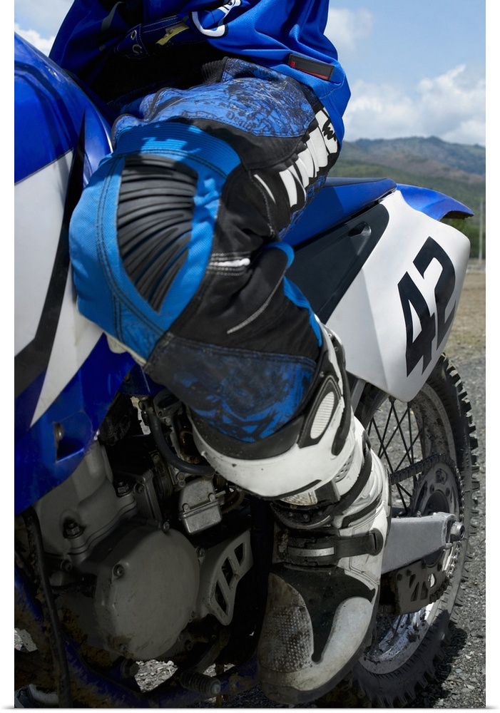 Low section view of a motocross rider riding a motorcycle