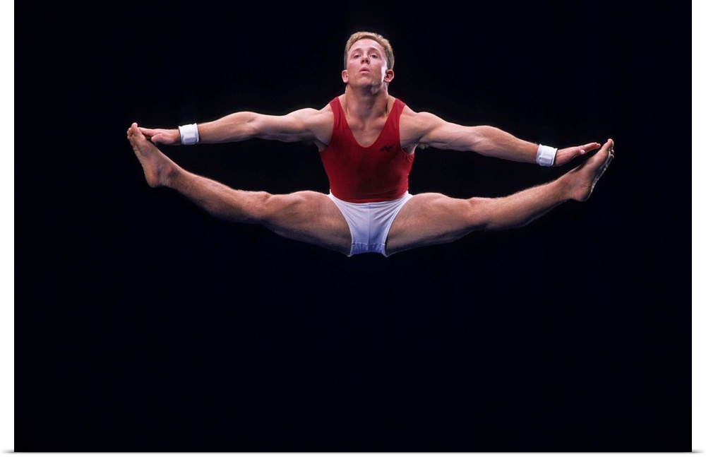 Male gymnast performing on the floor exercise