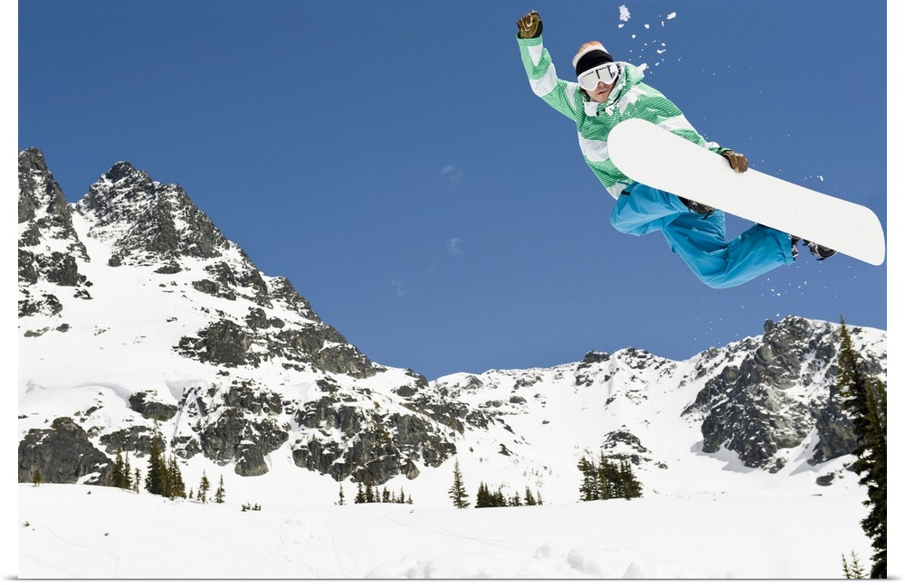 male snowboarder jumping in air