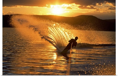 Man waterskiing at dusk