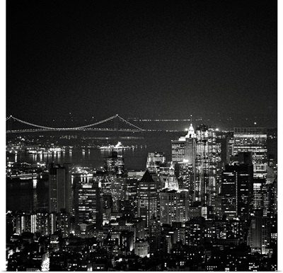 Manhattan, New York City at night with Hudson River and Brooklyn Bridge towards.