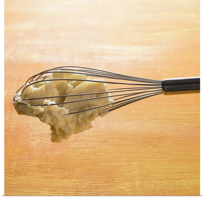 Mashed potato hanging on a whisk