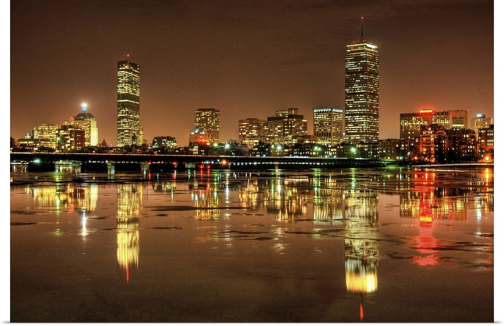 Massachusetts Avenue Bridge and Boston skyline with reflection in Charles river at night in Cambridge, Massachusetts.