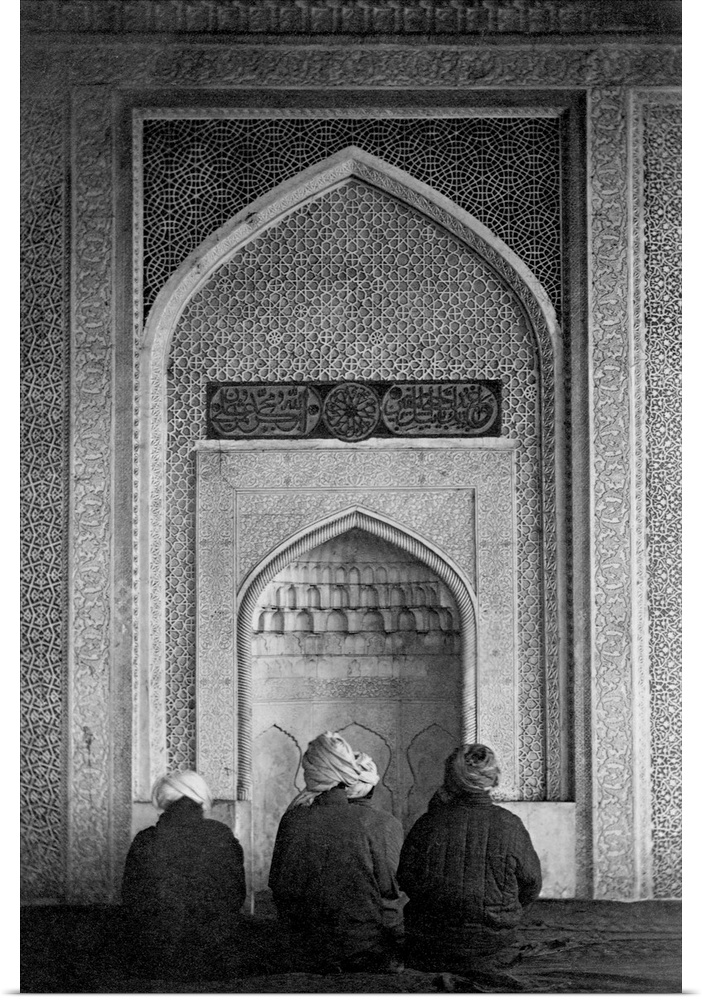 Four Muslims pray at the qibla niche, a recessed part of a mosque wall which shows the direction of Mecca, at the Kok Gumb...