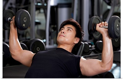 Mid-Adult Man Lifting Weights