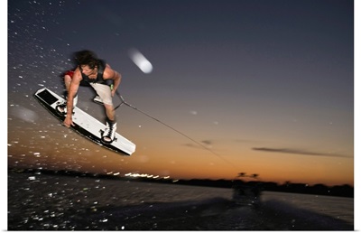 Midair wakeboarder at sunset