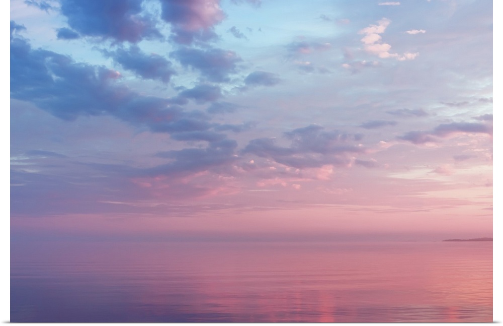 Misty lilac seascape with pink and blue clouds over the water of Lake Onega, Russia, Republic of Karelia.