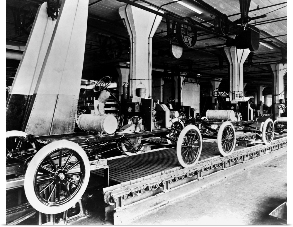 A line of Model T automobiles await further assembly. The Highland Park Ford Plant in Michigan is considered to be the bir...