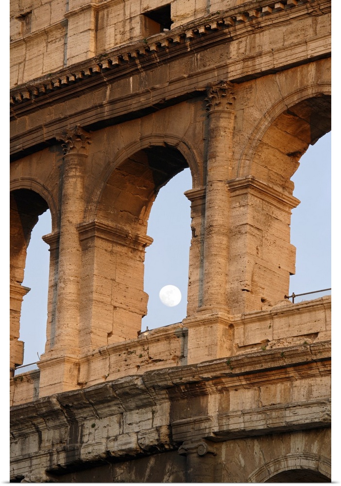 Vertical photo on canvas of the moon shining through an opening of one of the arches in the Colosseum.