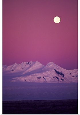 Moonrise over snowy mountain
