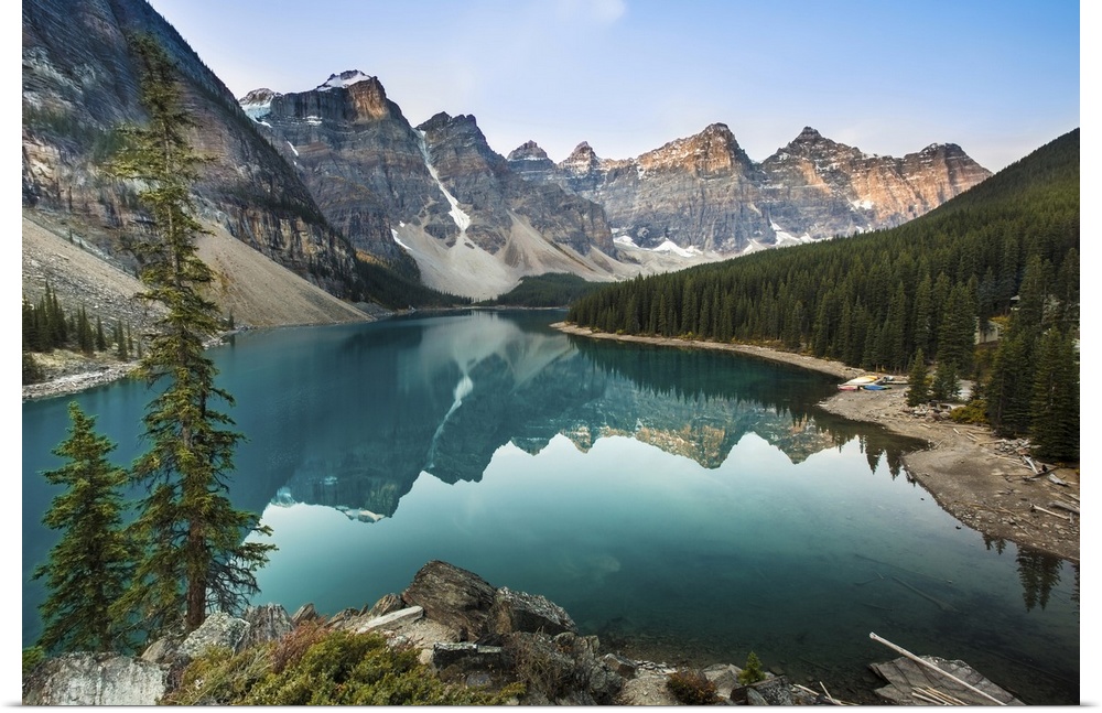 Moraine Lake right after sunrise time, sun light adds red color to the peaks around with reflection on the lake.  Shooting...