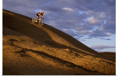 Mountain biker descending Slickrock Trail , Moab , UT