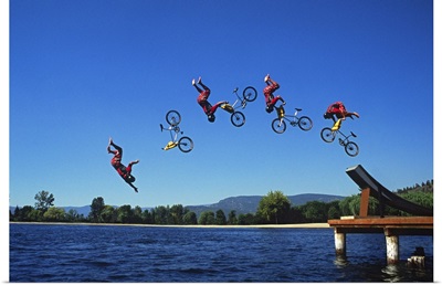 Multiple exposure of cyclist going off jump into water