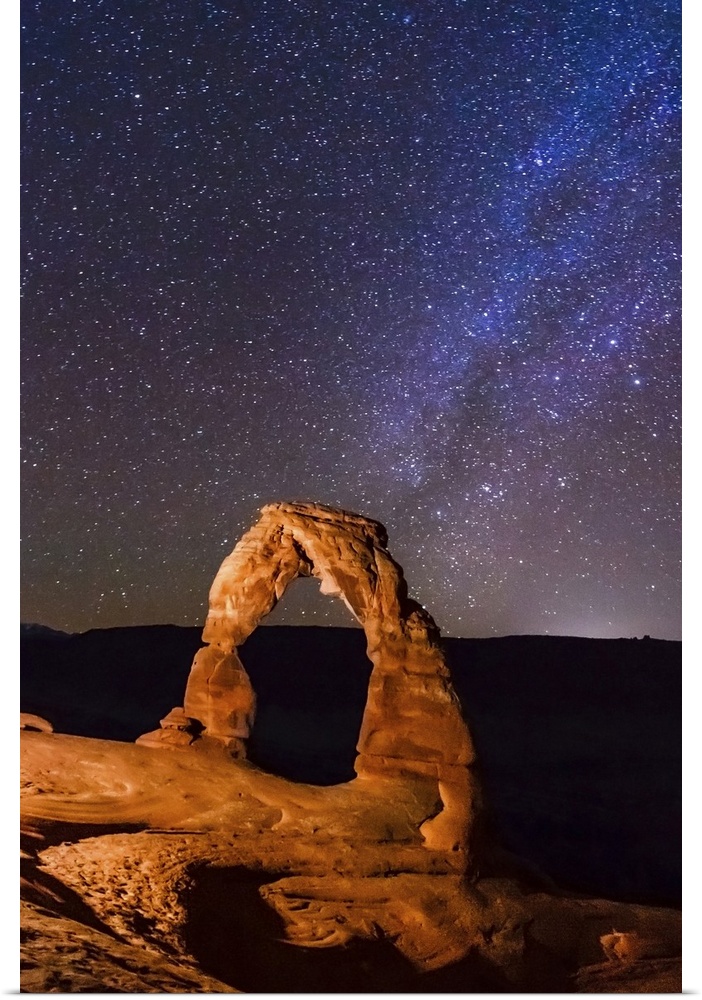 Night view of delicate arch and stars and Milky Way in southern sky, Arches National Park, Moab, Utah, United States.