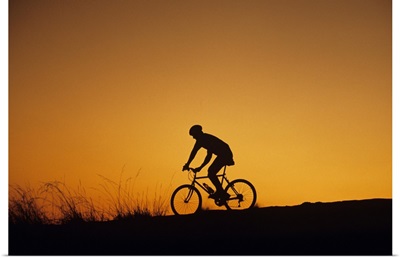 Off-road biker at sunset, Discovery Park, Seattle, Washington, USA
