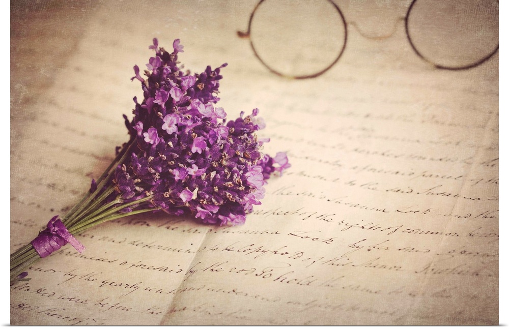 Old handwritten letter, pair of old fashioned round horn rimmed glasses and posy of lavender.