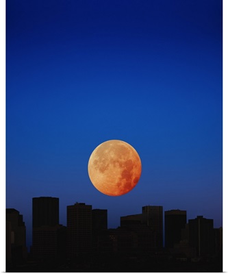 Orange moon in dark sky