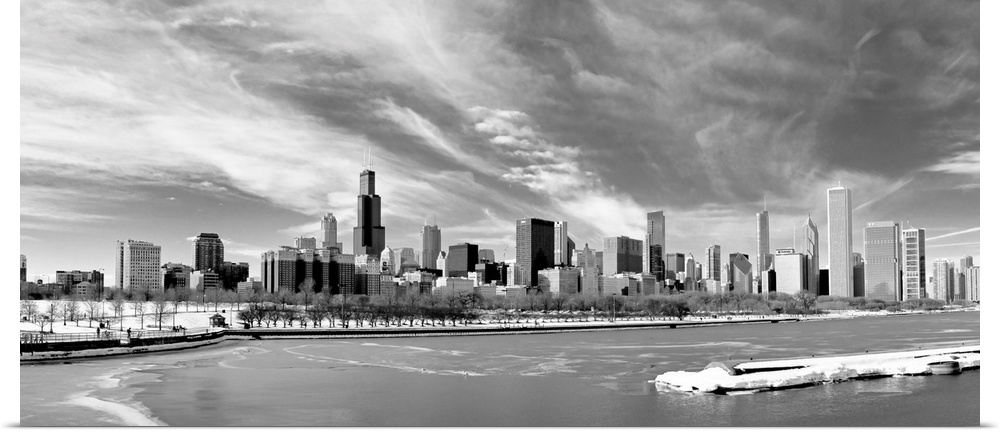 Landscape photograph on a large canvas of the Chicago skyline during winter, beneath a sky of wispy clouds, the waters in ...