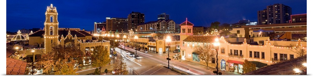 Panoramic view of the Country Club Plaza at dusk from above, lit up for the holidays.