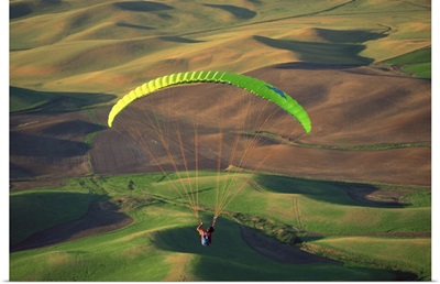 Paraglider flying over fields of Palouse region , Steptoe Butte , Washington
