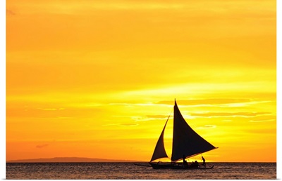 Paraw sailing at sunset, Philippines.