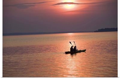 People kayaking at sunset