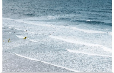 People learning to surf in the Atlantic ocean.
