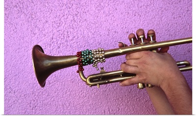 Person playing trumpet, close-up of hands