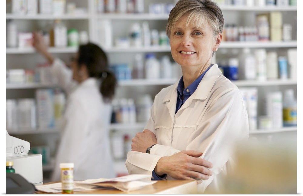 Pharmacists at counter of retail pharmacy