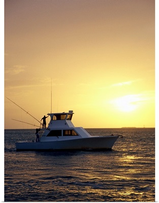 Photo, Silhouette view of a fishing boat during sunset