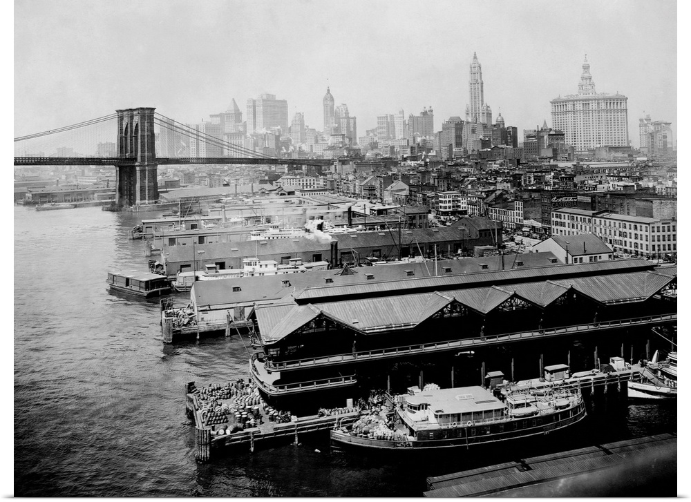 Piers line the East River to either side of the Brooklyn Bridge. New York City, ca. 1916.