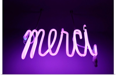 Pink and purple Neon light sign saying merci
