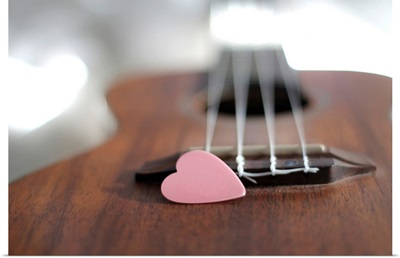 Pink heart on guitar.