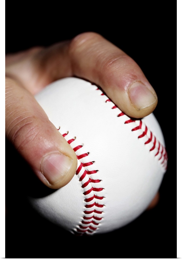 Pitchers hand gripping a baseball