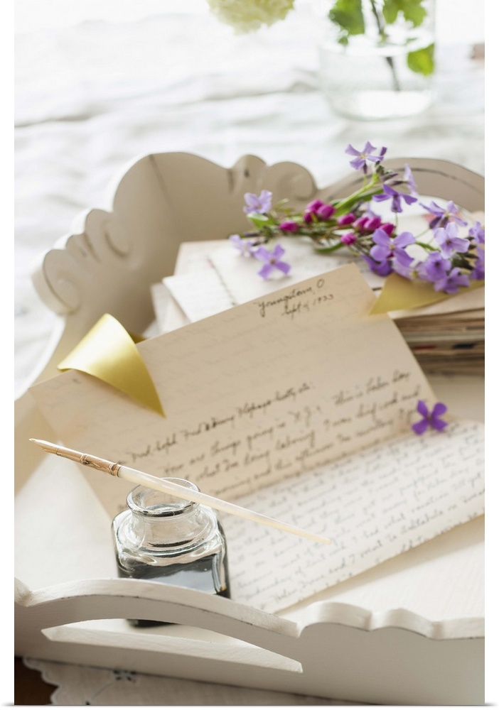 Quill pen with letters and flowers