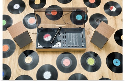 Records lying on floor surrounding 1970's stereo system