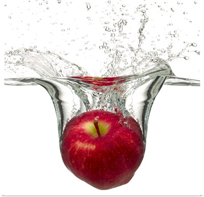 Red apple splashing in water