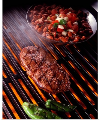 Rib eye steak on grill with beans