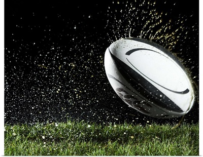 Rugby ball in motion over grass