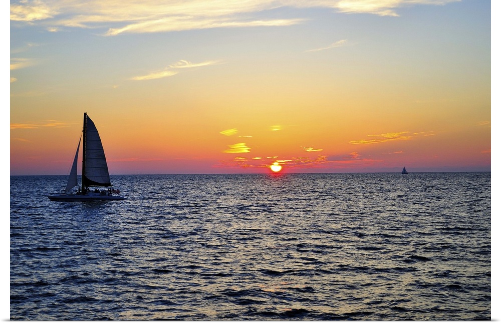 Sail boat on sea at sunset in Gulf of Mexico.