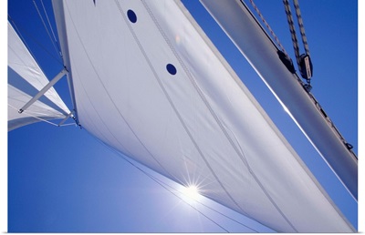 Sail on blue sky, close-up, low angle