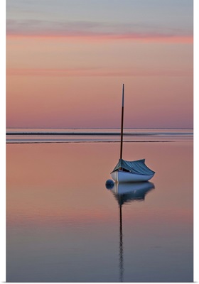 Sailboat and buoy at sunset.
