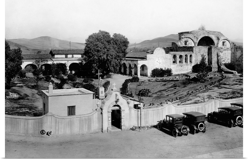Cars parked outside the walls of San Juan Capistranio Mission, California, May 1921.