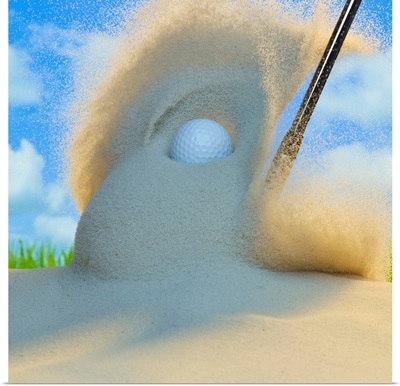 Sand wedge hitting a golf ball out of a sand trap