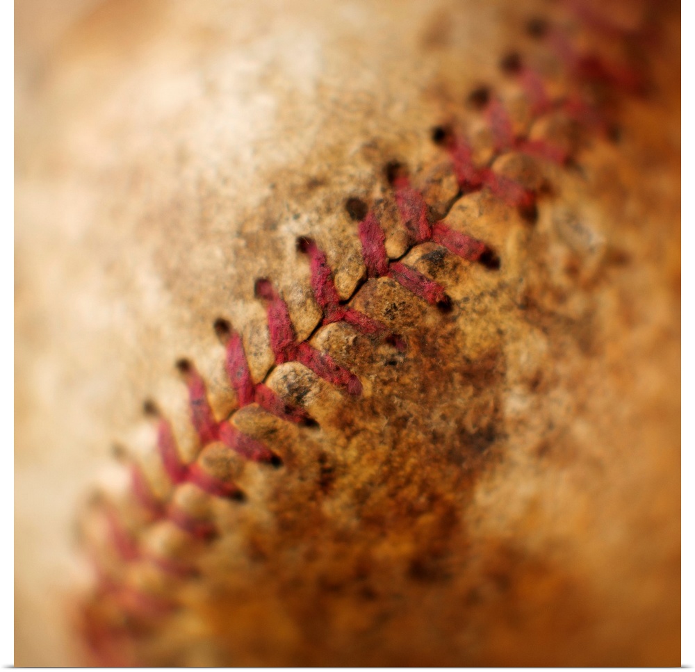 Big photograph emphasizes the stitching found on a worn ball made from cowhide that is used in the sport nicknamed "Americ...