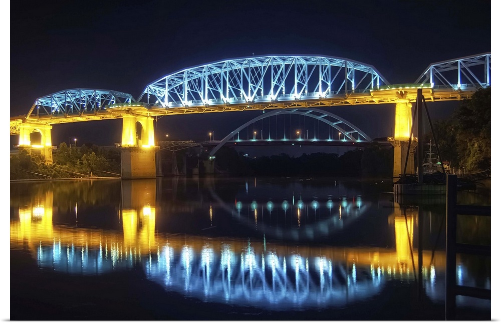 Night view of Shelby Street Pedestrian Bridge and reflection of lights in water.