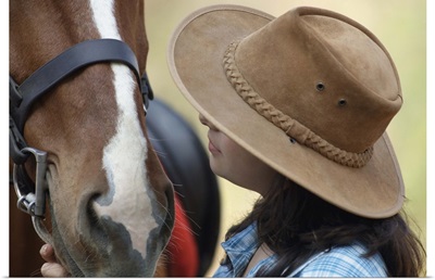 Side Profile Of A Teenage Girl Touching A Horse